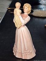 Front view of figurine showing mother holding infant