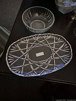 Oval cut crystal tray and clear glass bowl on table