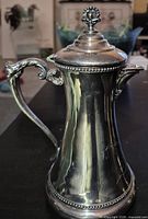 Left profile showing handle, lid, body finish and beaded rim