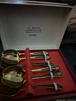 Open presentation box showing six gold-plated teaspoons
