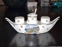 Cruet set assembled on tray showing scenic decal and gold trim