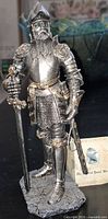 Front view of William the Conqueror figurine on base, showing armour detail and booklet