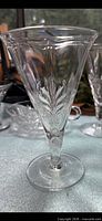 Clear glass Fostoria Baroque water goblet showing leaf motif and overall form