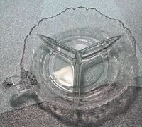 Top view showing tri-section layout, scalloped rim and handle