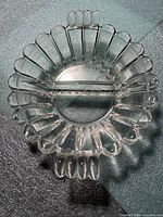 Top view of clear glass divided relish bowl showing scalloped rim, divider and handles