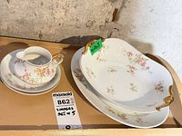 Group shot showing all five Limoges porcelain pieces with floral gilt pattern