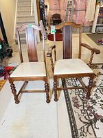 Front view of both chairs showing armchair and side chair, upholstery, leg style