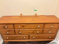 Front view of solid pine dresser chest with eight drawers and white knobs