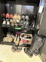 Overall view of both shelves with multiple shoe pairs and tall boots