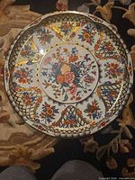 Front view of enamel floral charger showing pattern and colors