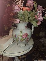 Full view of porcelain pitcher with artificial flowers
