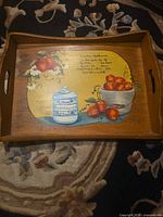 Full view of wooden tray showing hand-painted fruit scene and cutout handles