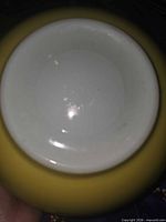 Underside showing white glazed base within yellow exterior