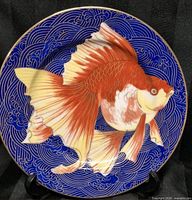 Front view showing goldfish motif and wave background