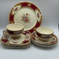 Front view of plates, cups and saucers showing Vincent pattern