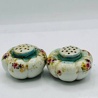 Top view showing both shakers with floral design and perforated tops