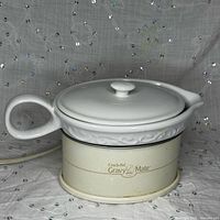 Gravy warmer assembled showing ceramic boat with lid on electric base