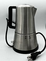 Side view of stainless steel espresso maker with cord