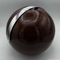Closed brown spherical ice bucket showing chrome handle