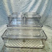 Five clear plastic produce organizers displayed; four small on top of one long