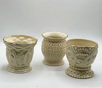 Front view of three ivory Lenox beaded tealight jars
