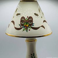 Full view of porcelain lamp shade showing holly, berries and tartan ribbon design with gold rim