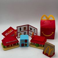 Complete set showing two buildings, play structure, Happy Meal box, takeout bag, menu card, insert card
