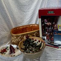 Group shot showing Lemax box, gold planter, round tree bowl, oval dish, beeswax candle