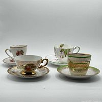 Front view of four cup and saucer sets