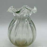 Front view of clear glass vase showing ribbed body and ruffled rim