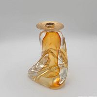Front view showing amber swirl glass body and brass holder