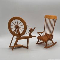 Miniature spinning wheel and rocking chair front view