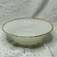 Side view showing scalloped edge and gold trim