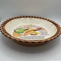 Oblique view of pie plate showing scalloped rim and interior recipe graphic