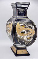 Front view showing cobalt glaze, gold slip detailing and floral motifs