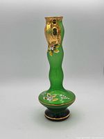 Full front view of green glass vase showing gold gilt and enamel floral decoration