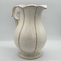 Front view of cream ceramic pitcher