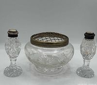 Front view of crystal bowl with brass flower frog and two matching shakers