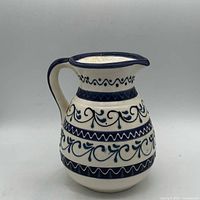 Front view of blue and white hand painted pitcher