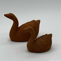 Two handmade terracotta clay swan figurines front view