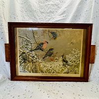 Full frontal view of wood tray showing bird print and handles