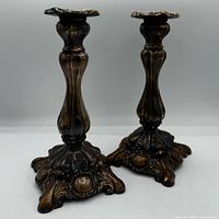 Front view of both candlesticks standing upright