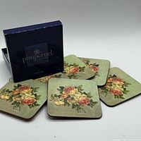 Coasters arranged around Pimpernel box, showing floral fronts