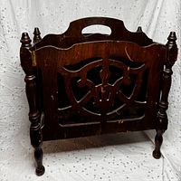 front view showing carved panel, spindle supports, legs