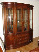 Front view of the Stanley china cabinet showing glass display doors, drawers, and wood cabinets.