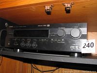 Front view of Yamaha HTR-5240 AV Receiver showing control knobs, input selector, volume control, and front panel.