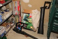 Toro Super Blower Vac and Homelite HedgeSweep hedge trimmer box and hardware in garage environment.