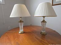 Both crystal bedside lamps on table showing full view with shades