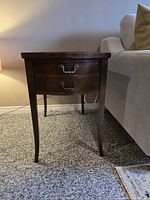 Front view showing drawer and legs