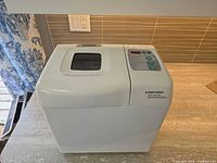 Front and top view of breadmaker showing overall condition